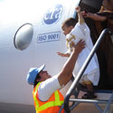 UN police helping a child coming out of a plane