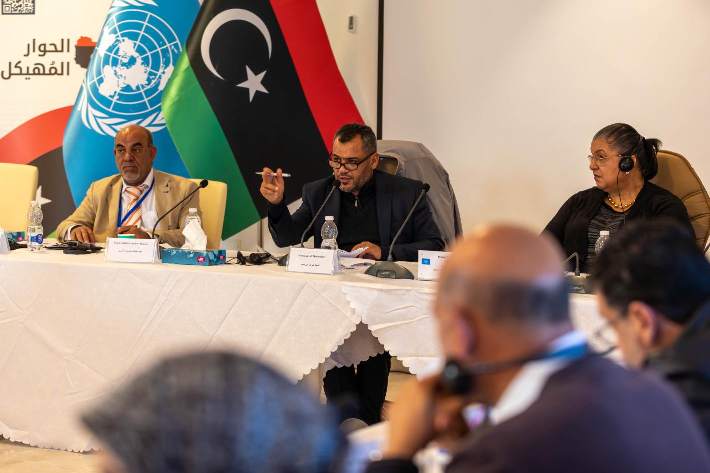Two bureau members of the Governance Track of the Structured Dialogue sits at a table with SRSG Hanna Tetteh, leading a discussion
